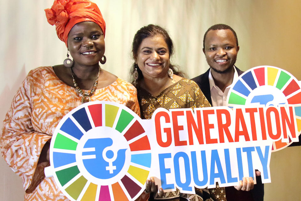 UN Women staff hold up Generation Equality signs. Photo: UN Women/Kennedy Okoth